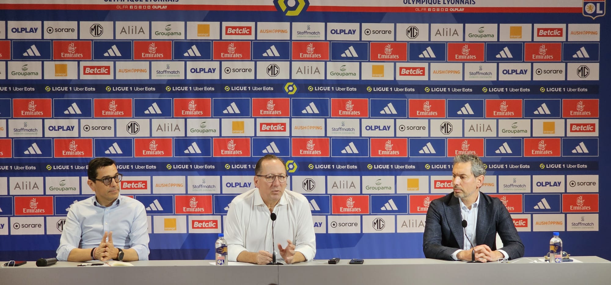 David Friio, directeur sportif de l'OL (à droite), assis aux côtés du président John Textor et de Laurent Prud'homme, directeur généra